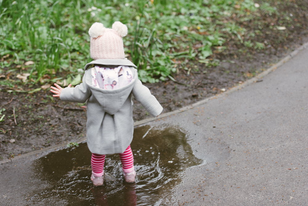 Cute Little girl in puddle